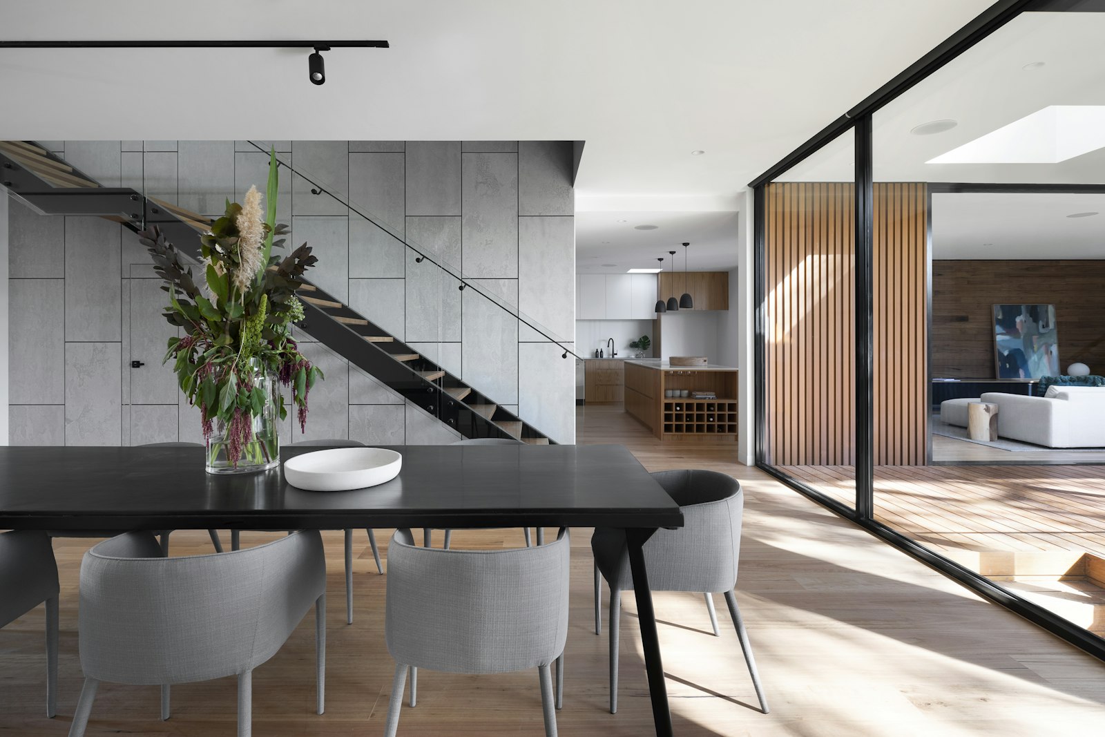 Open residential living space with tall ceilings and warm wood details