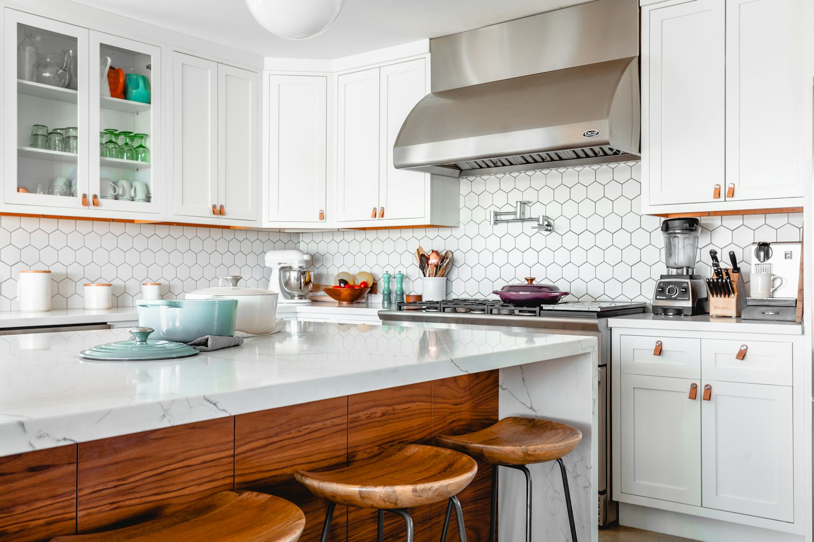Light-filled kitchen with white cabinetry and natural wood accents